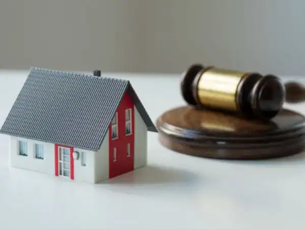 Image of an auction property showcasing a house and a hammer